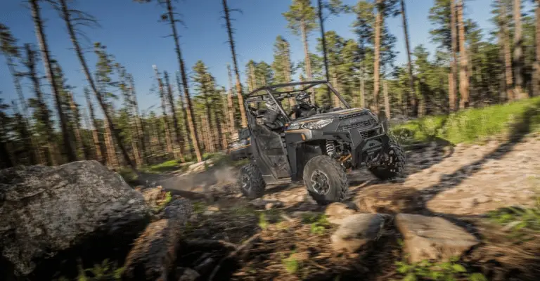 A Polaris Ranger offroading in the woods, using its Turf Mode functionality