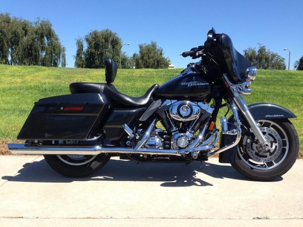 Black Harley-Davidson Electra Glide touring motorcycle with batwing fairing and hard saddlebags parked outdoors