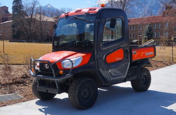 Kubota RTV-X1100C side-by-side utility vehicle with enclosed cab parked outdoors
